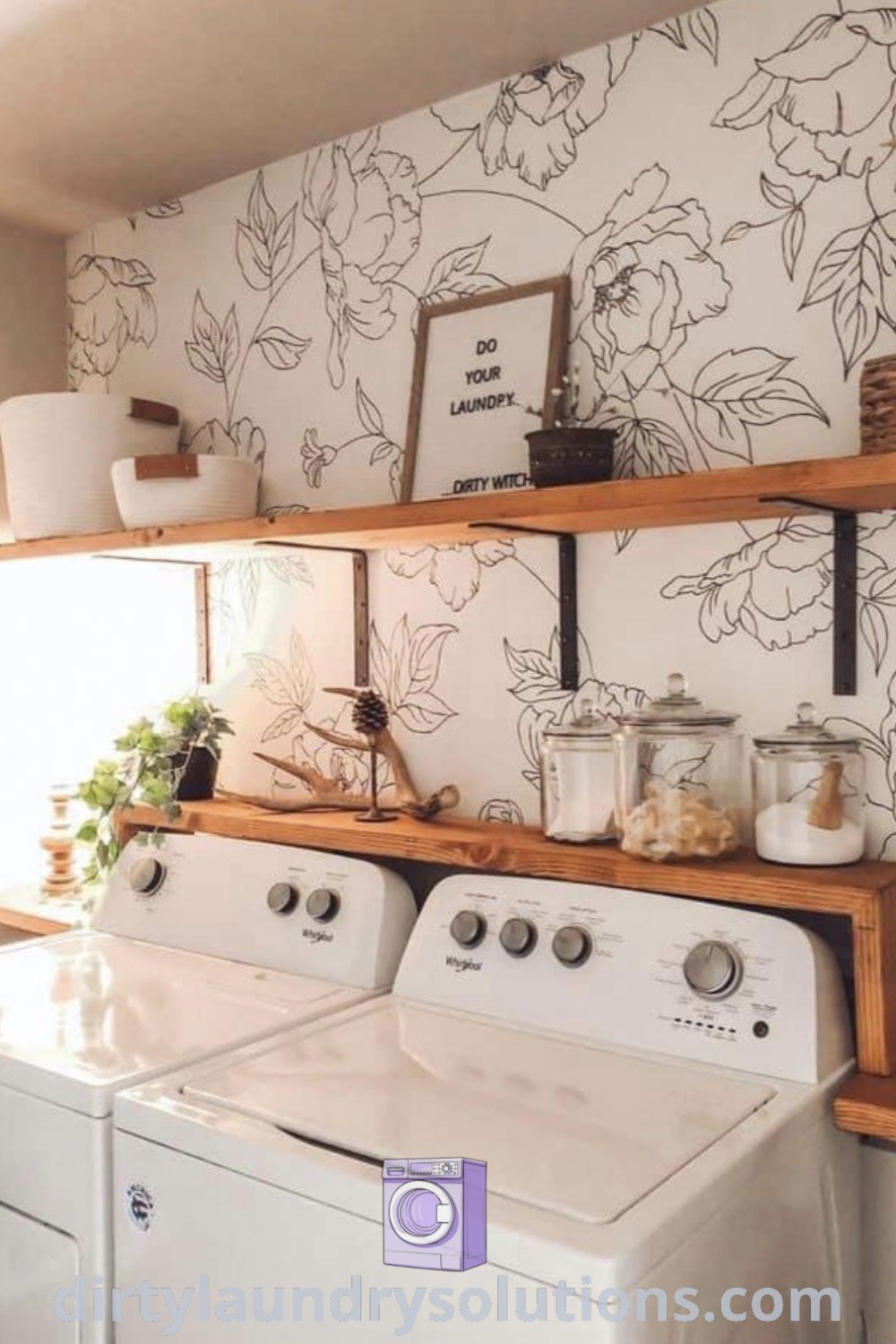 A laundry room featuring a washer and dryer framed by floral wallpaper, exemplifying cozy home decor and organization ideas. Discover more inspiring laundry room designs and solutions at dirtylaundrysolutions.com.