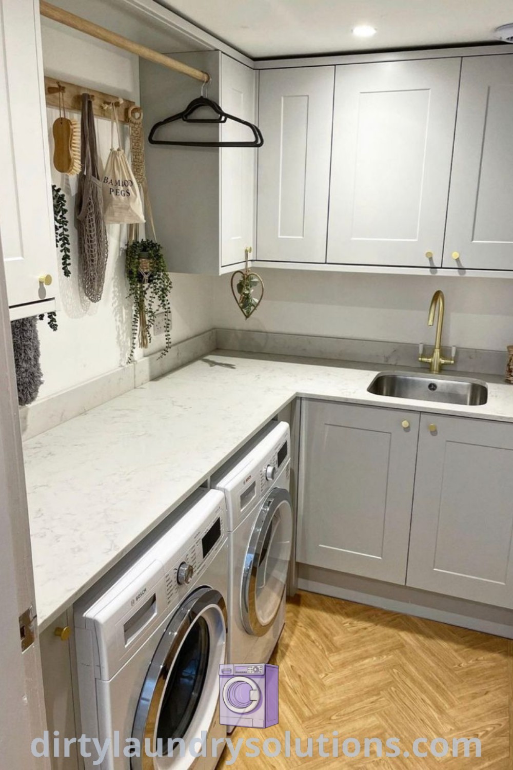 A light grey utility room showcasing a washer and dryer in an L-shaped layout, complete with a small sink, perfect for maximizing space and organization. Discover inspiring small utility room ideas and solutions at dirtylaundrysolutions.com.