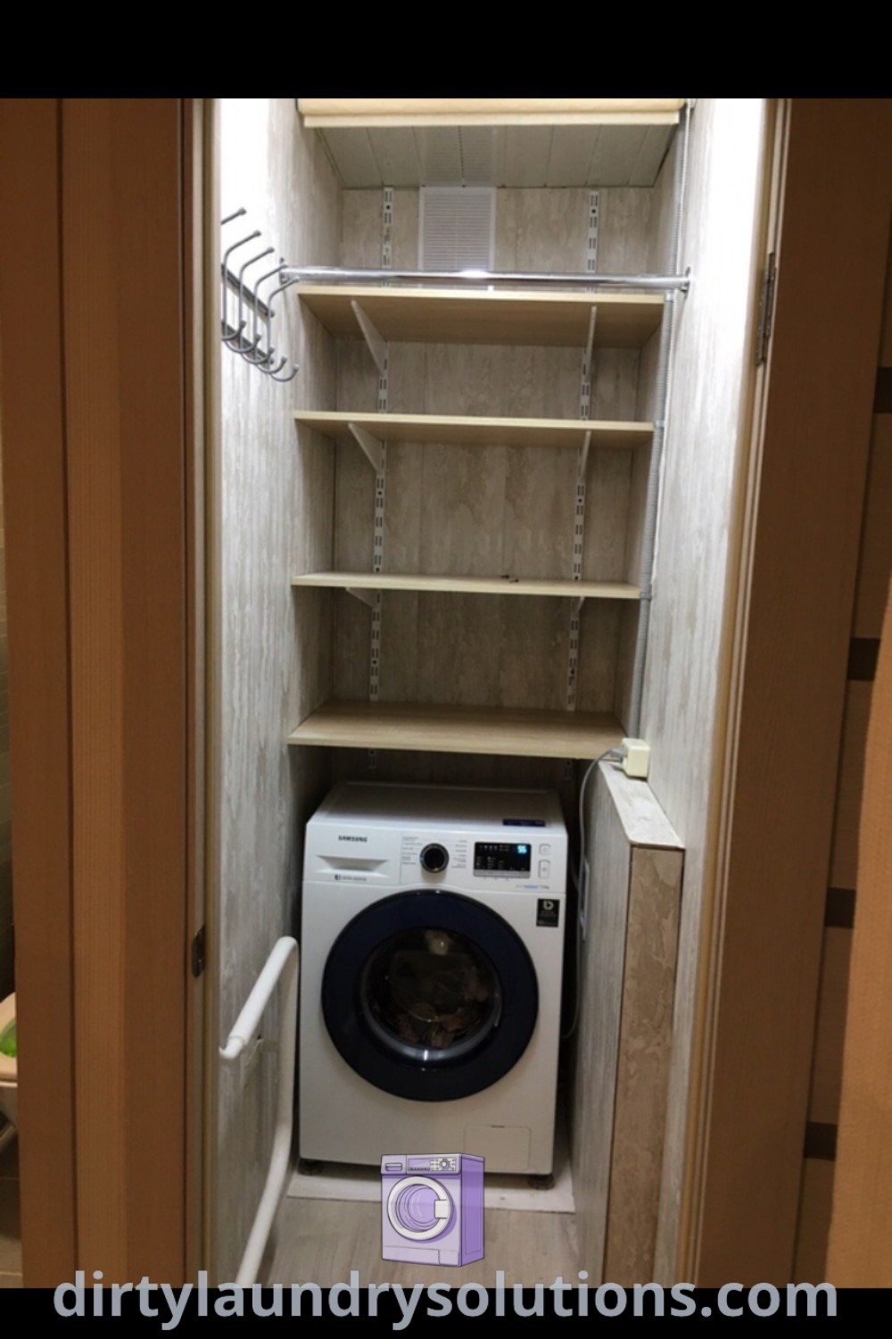 A cozy laundry room featuring a washer and dryer in a closet with shelves on either side, demonstrating functional space and organization ideas. Discover more unique solutions for your laundry space at dirtylaundrysolutions.com.