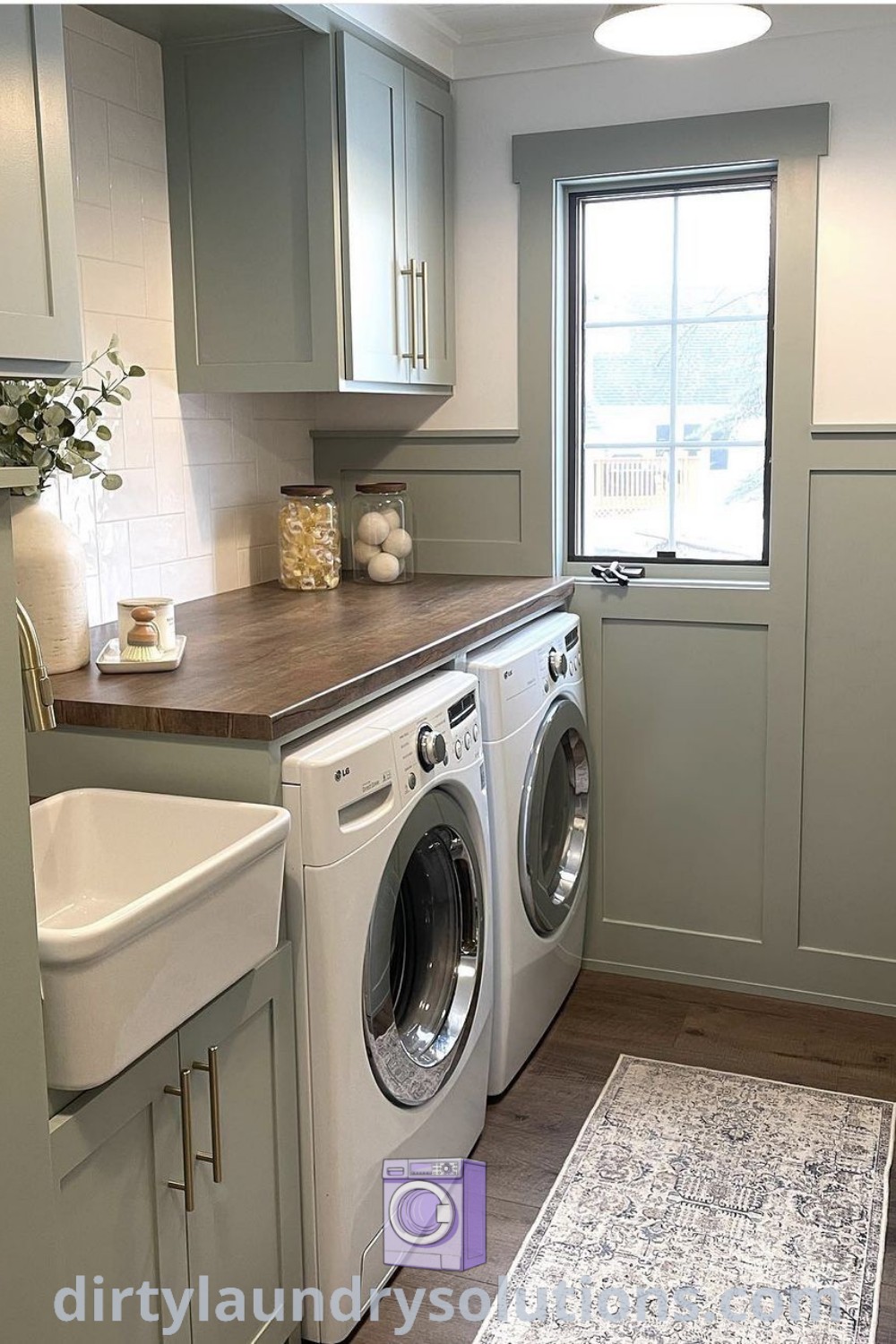 A small laundry room featuring a washer and dryer, gray wainscoting, and cabinets to the ceiling, exemplifying organization ideas for cozy aesthetics. Discover inspiring laundry room renovations and ideas you