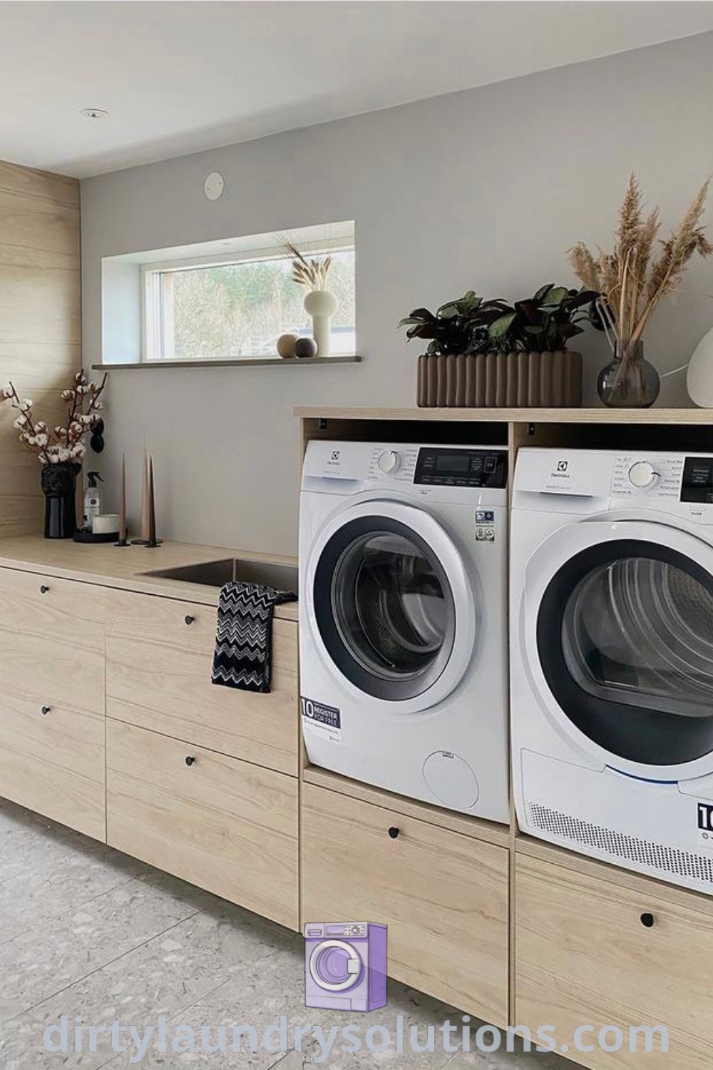 A spacious laundry room with a washer and dryer, surrounded by wood cabinets, showcasing modern designs and cozy organization ideas for busy homes. Discover unique solutions and inspirations for your laundry room at dirtylaundrysolutions.com.