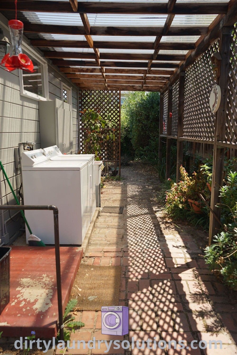 An outdoor laundry area featuring a washing machine, designed for functionality and style as an outside laundry room. Discover inspiring ideas and solutions for your space at dirtylaundrysolutions.com.
