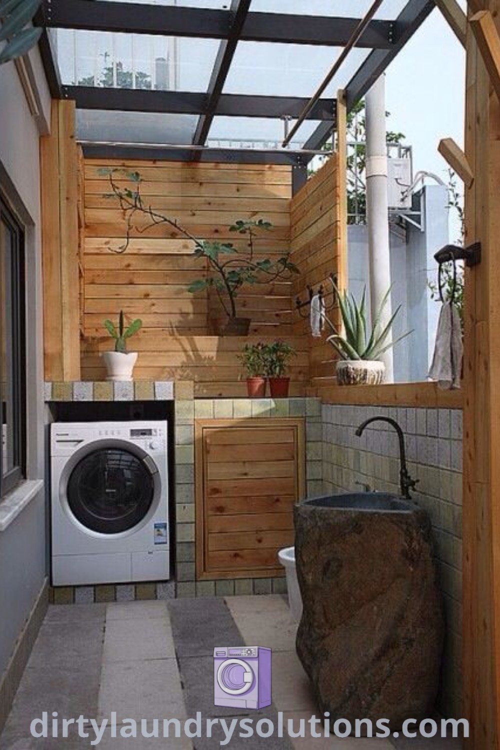 A cozy outdoor laundry room with a washer and dryer surrounded by wood paneling, ideal for small apartment balcony gardens. Discover more stylish and functional laundry design ideas at dirtylaundrysolutions.com.
