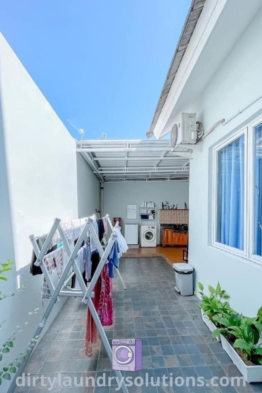 An outdoor laundry space with clothes hanging to dry in the sun, showcasing a cozy design idea for homes. Explore functional inspirations for your outdoor laundry room at dirtylaundrysolutions.com.