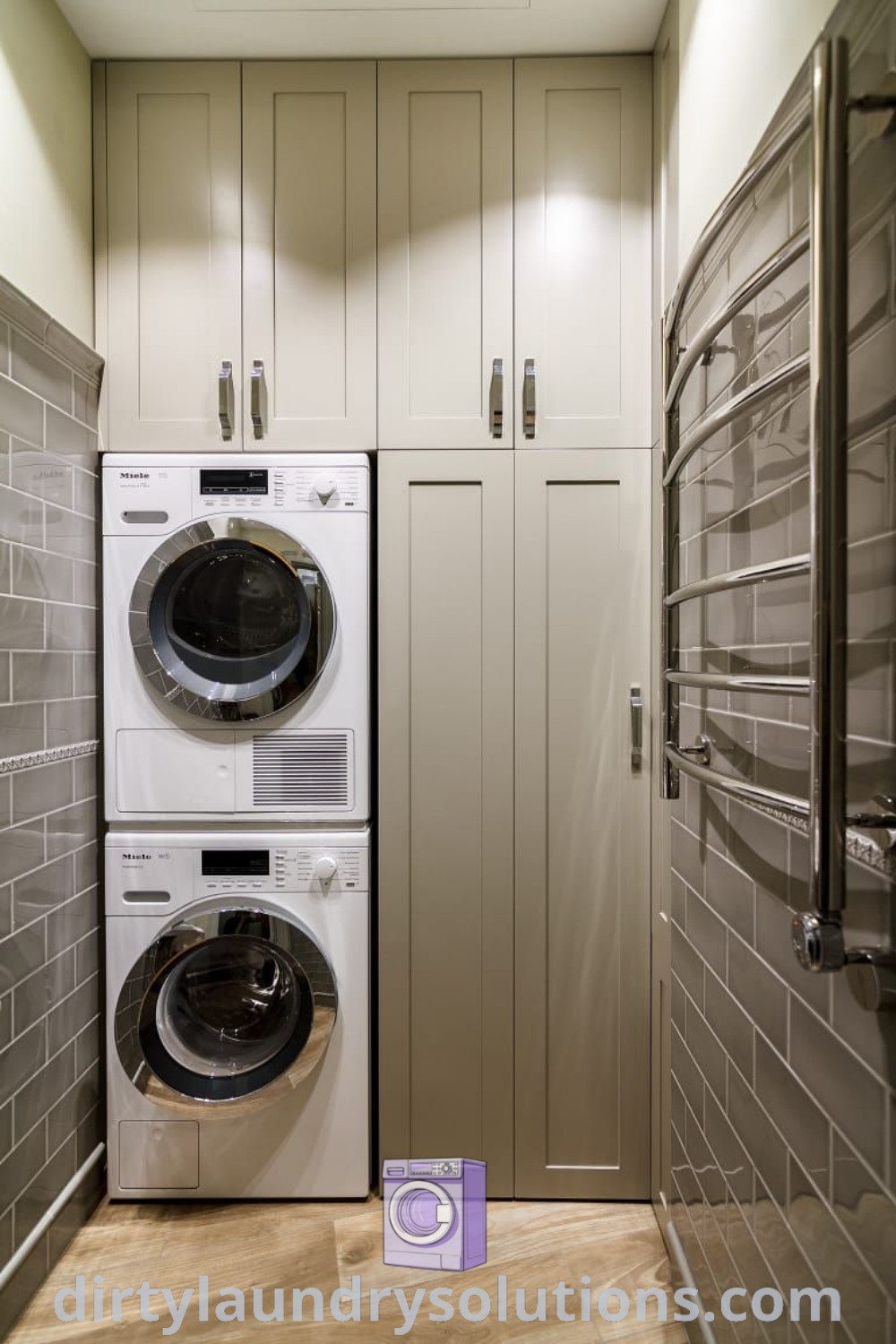 A small utility toilet room showcasing a double stacked washer and dryer with white cabinets on both sides, ideal for laundry area makeovers. Discover cozy design ideas and organizational solutions at dirtylaundrysolutions.com.