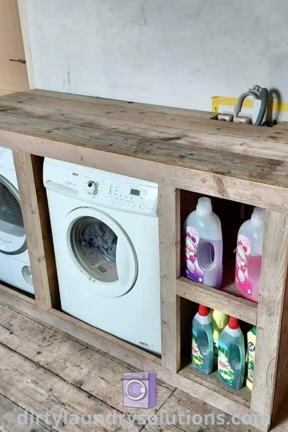 A washer and dryer sitting next to a wooden shelf in an outdoor setting, illustrating innovative outdoor washer and dryer ideas. Discover practical solutions and inspiring design ideas for your home at dirtylaundrysolutions.com.