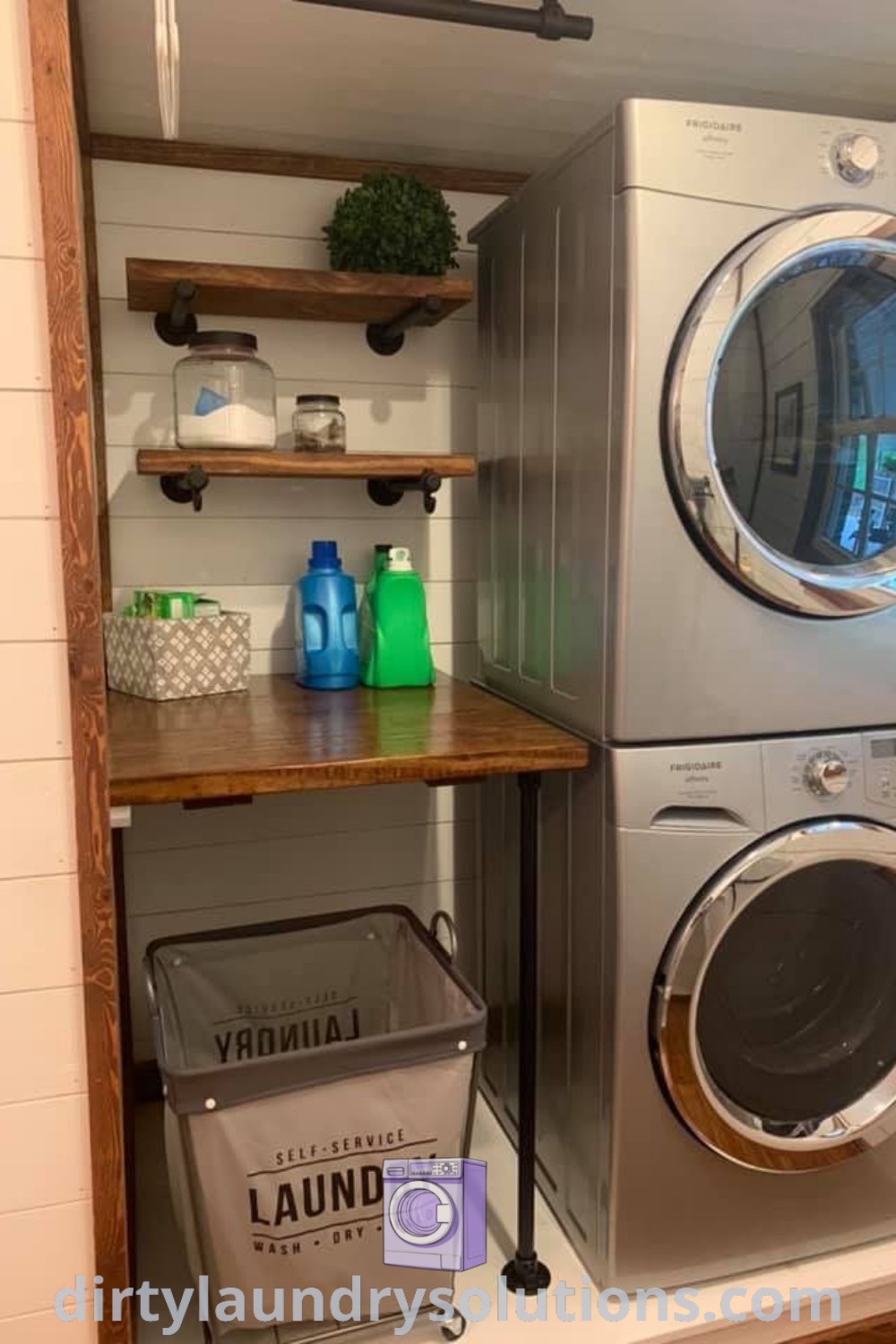 A cozy tiny laundry room featuring a stacked washer and dryer with shelves above for storage, demonstrating efficient design ideas for small spaces. Find more organization ideas and solutions at dirtylaundrysolutions.com.