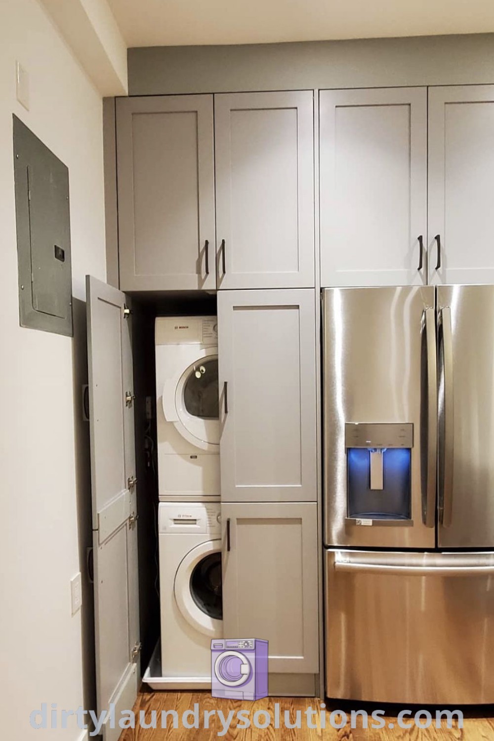 A stainless steel refrigerator and washer in a room with white walls, wood flooring, and cabinets, demonstrating a stylish kitchen laundry combo. Discover unique ideas and organization tips for your home at dirtylaundrysolutions.com.
