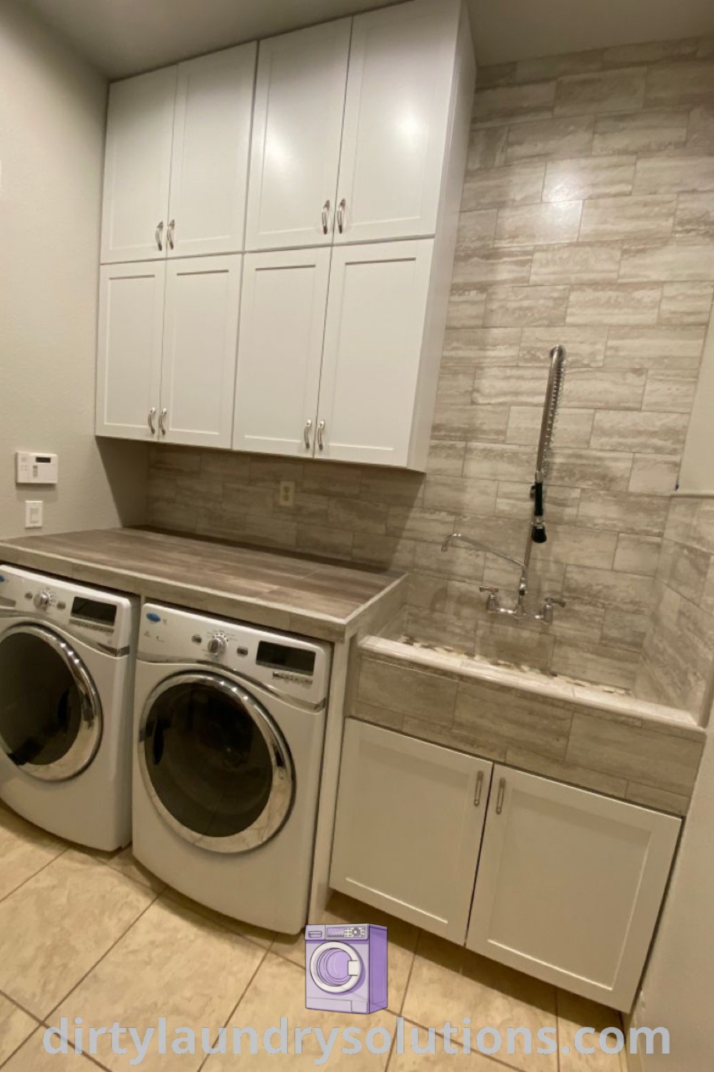 A laundry room with a custom dog wash area replacing a deep sink, exemplifying mobile home wash room ideas. Small laundry room features include dog washing sink and counter space, showcasing organization ideas for busy homes. Explore more cozy ideas at dirtylaundrysolutions.com.