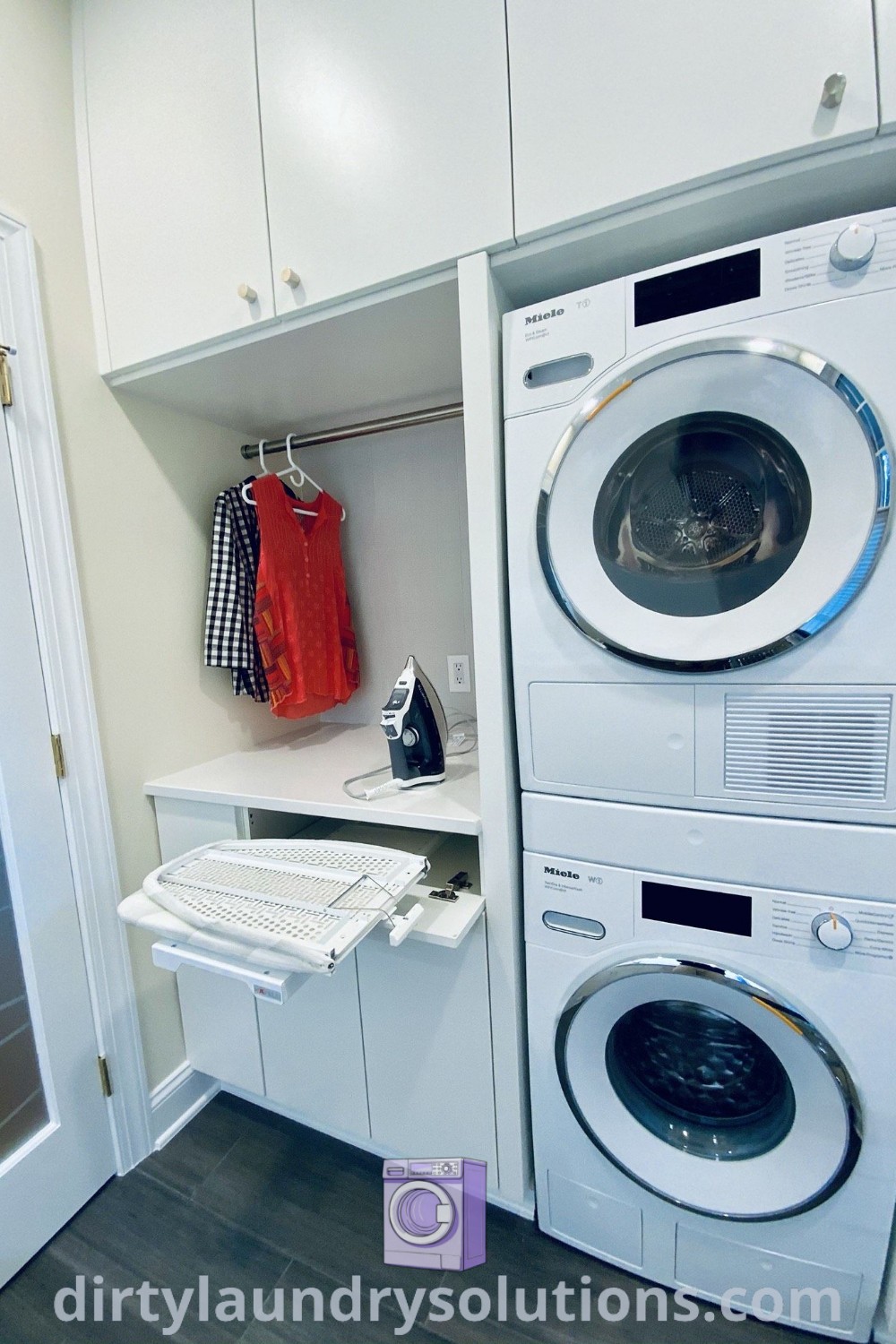A cozy stacked laundry room with a white washer and dryer next to a closet and white cabinets, showcasing organization ideas and small space inspirations for modern laundry rooms. Discover more at dirtylaundrysolutions.com.