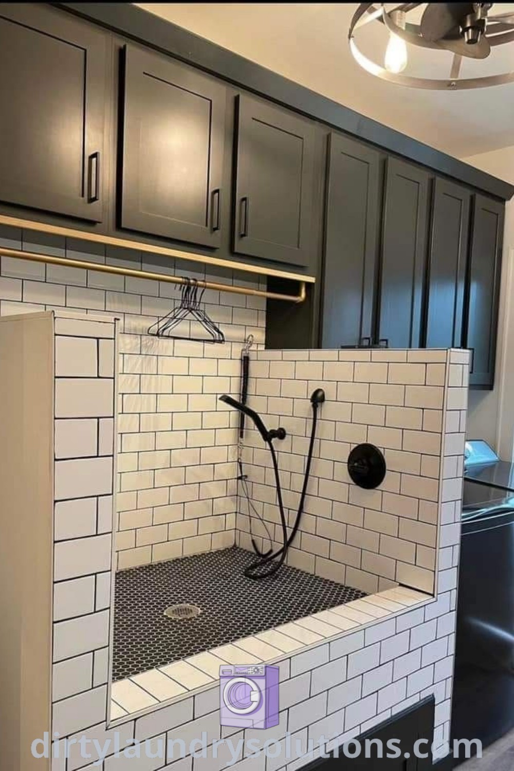 A stylish bathroom featuring black cabinets, white subway tiles, and a walk-in shower designed as a dog wash station, combining functionality with modern aesthetics. Discover unique ideas for organizing your pet care space at dirtylaundrysolutions.com.