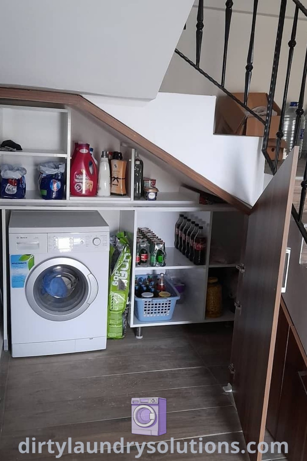A washer and dryer tucked under a staircase in a small space, illustrating efficient organization ideas for homes. Discover cozy and inspiring designs for small spaces at dirtylaundrysolutions.com.
