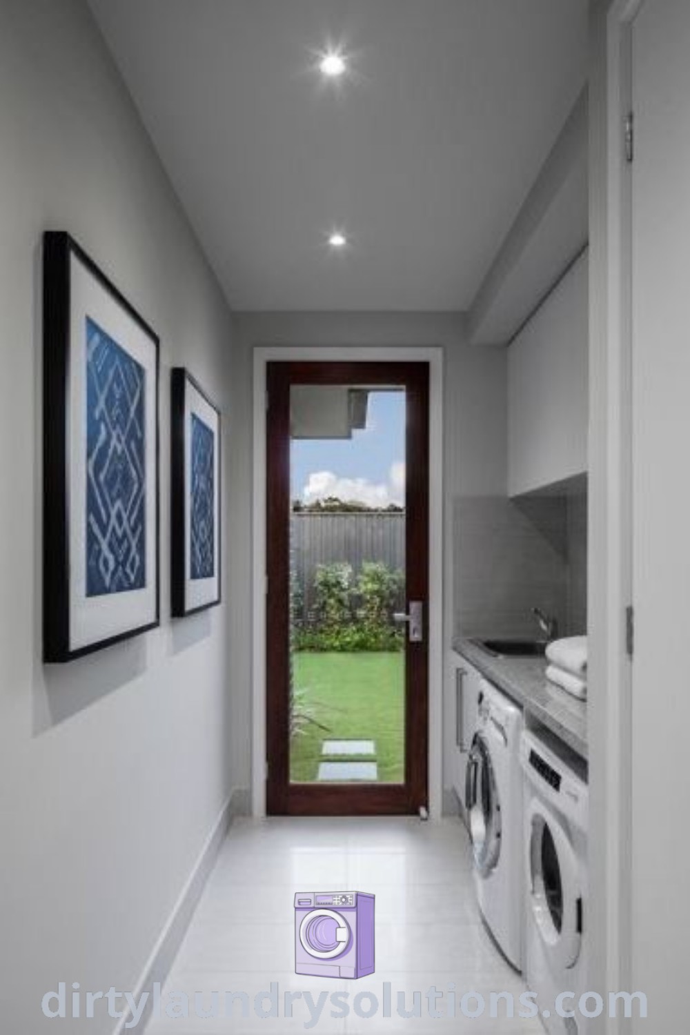 A laundry room showcasing a washer and dryer beside a doorway, with decorative pictures on the wall, reflecting beautiful house designs and stylish organization ideas. Discover more inspiring laundry solutions at dirtylaundrysolutions.com.