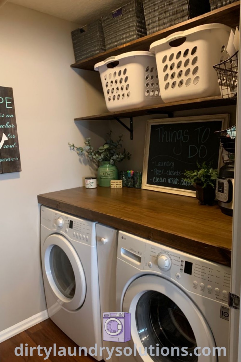 A cozy laundry room showcasing a washer and dryer next to a chalkboard sign, with wood countertops and hanging laundry baskets, exemplifying organization ideas and unique designs for small spaces. Find more inspiring solutions at dirtylaundrysolutions.com.