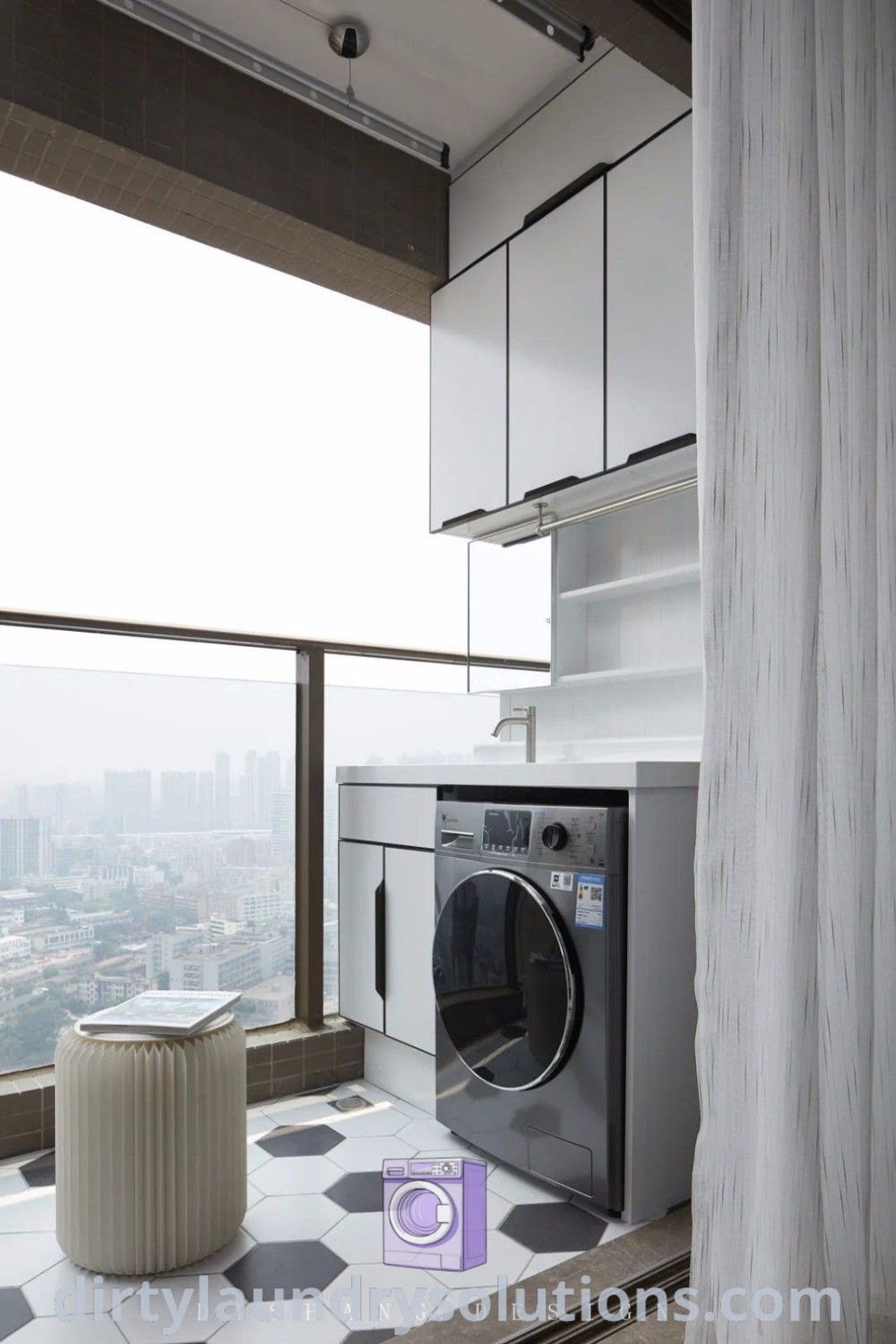 A washer and dryer in a small balcony laundry area with a large window, surrounded by a cozy aesthetic and outdoor decor ideas. Discover more cozy solutions for laundry spaces at dirtylaundrysolutions.com.