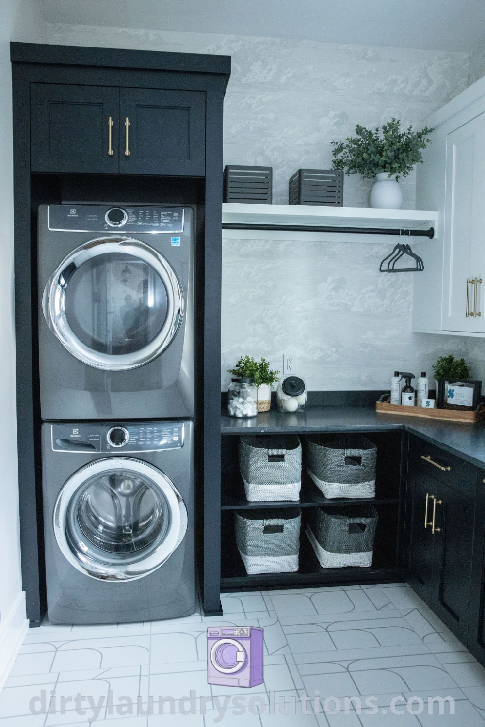 A modern laundry room showcasing a stackable washer and dryer against white tile flooring and black cabinets, designed for efficiency and style. Discover more inspiring laundry room designs and ideas at dirtylaundrysolutions.com.