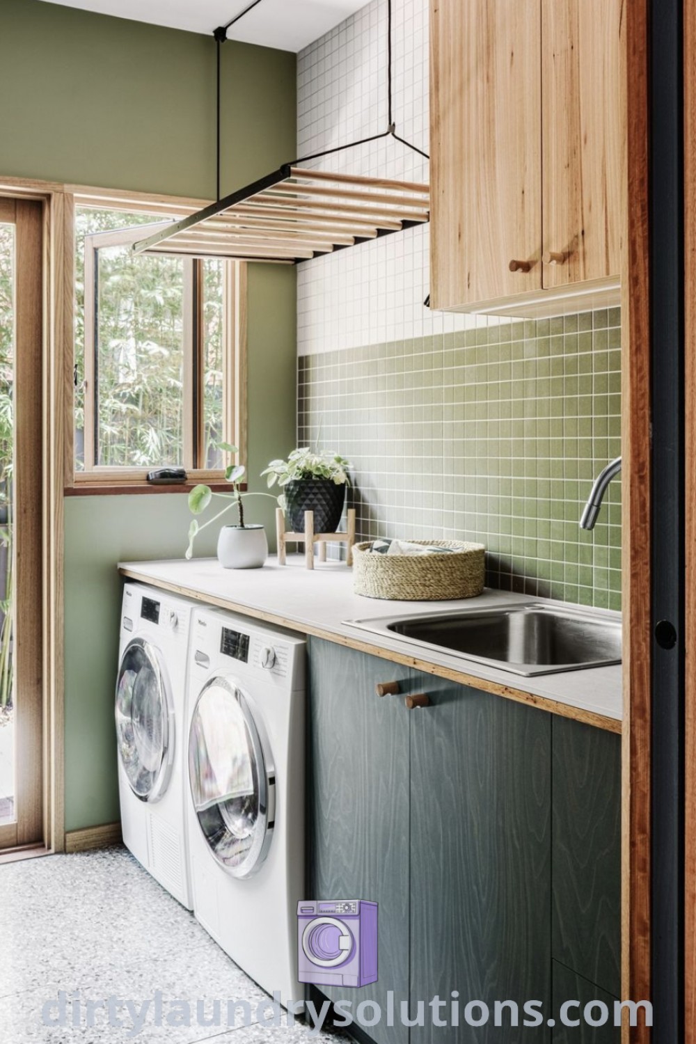 A stylish laundry room with a washer and dryer surrounded by green tiles and wooden cabinets, showcasing organization ideas for small spaces. Discover more cozy home inspirations and solutions at dirtylaundrysolutions.com.
