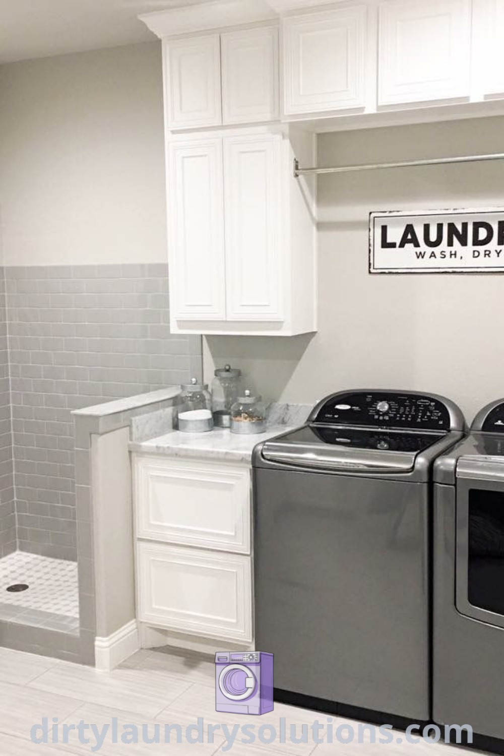 A cozy laundry room featuring a washer and dryer with unique decor and shower floor tiles, showcasing organization ideas and inspiring layouts for your home. Discover more solutions for laundry design at dirtylaundrysolutions.com.