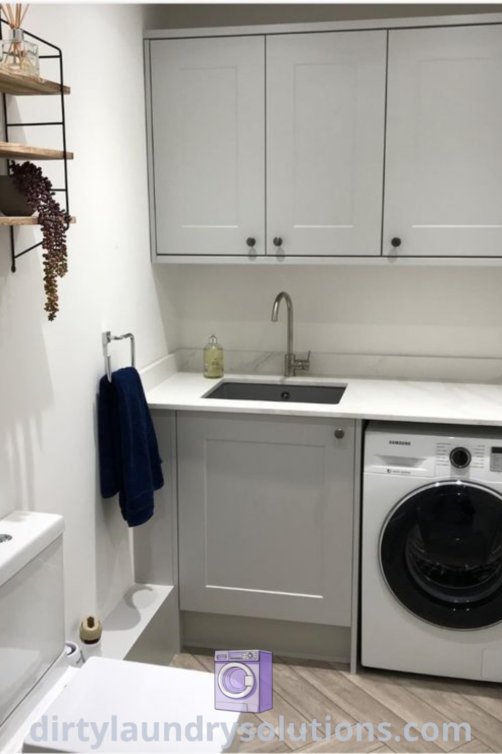 A cozy utility room with a washer and dryer, white cabinets on the walls, and a toilet, showcasing a functional design for small spaces. Discover creative utility room storage ideas and inspiring solutions at dirtylaundrysolutions.com.