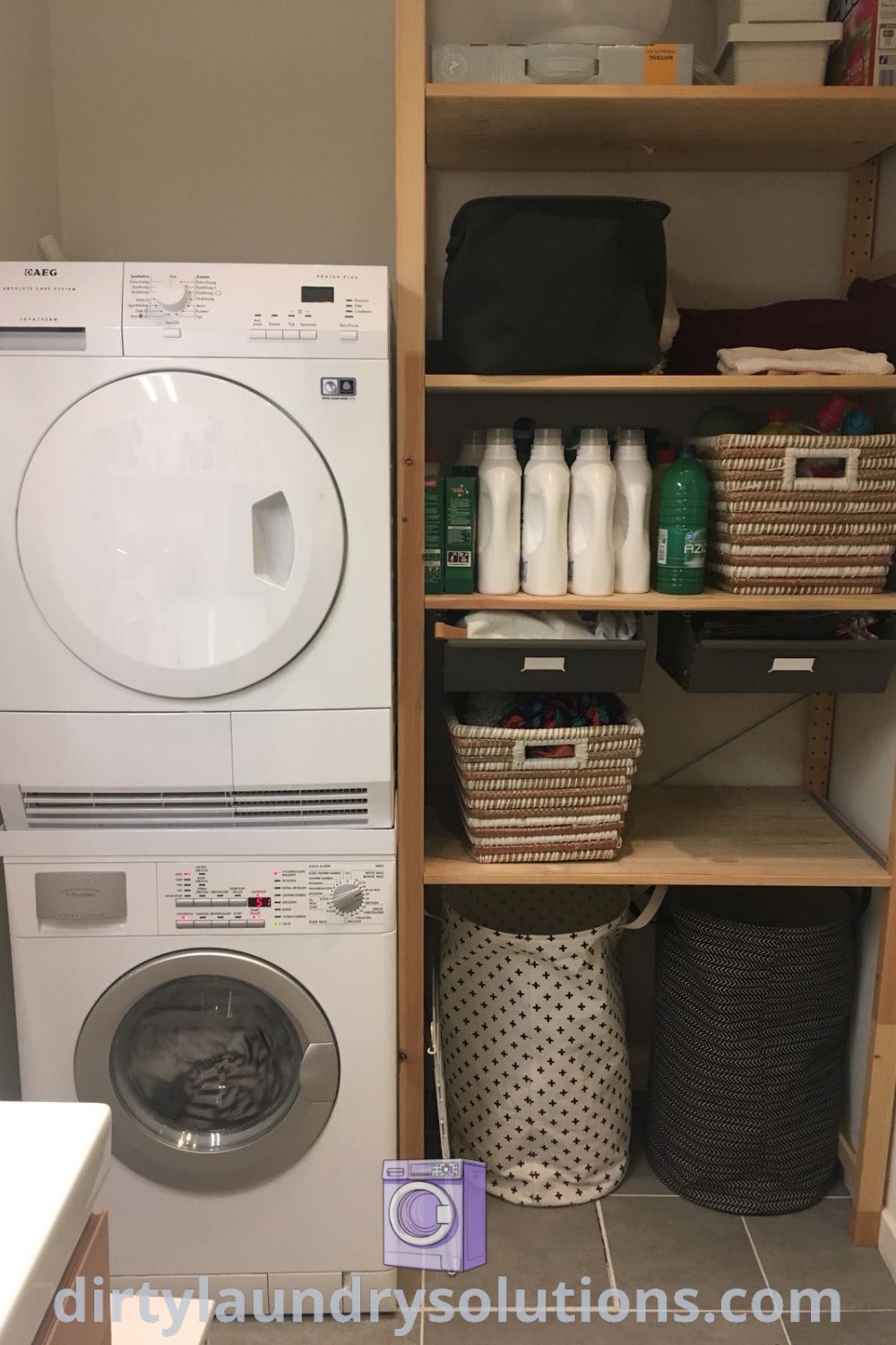 A compact laundry room with a stacked washer and dryer next to open shelves, showcasing efficient organization ideas for small spaces. Explore more stacked laundry room inspirations at dirtylaundrysolutions.com.