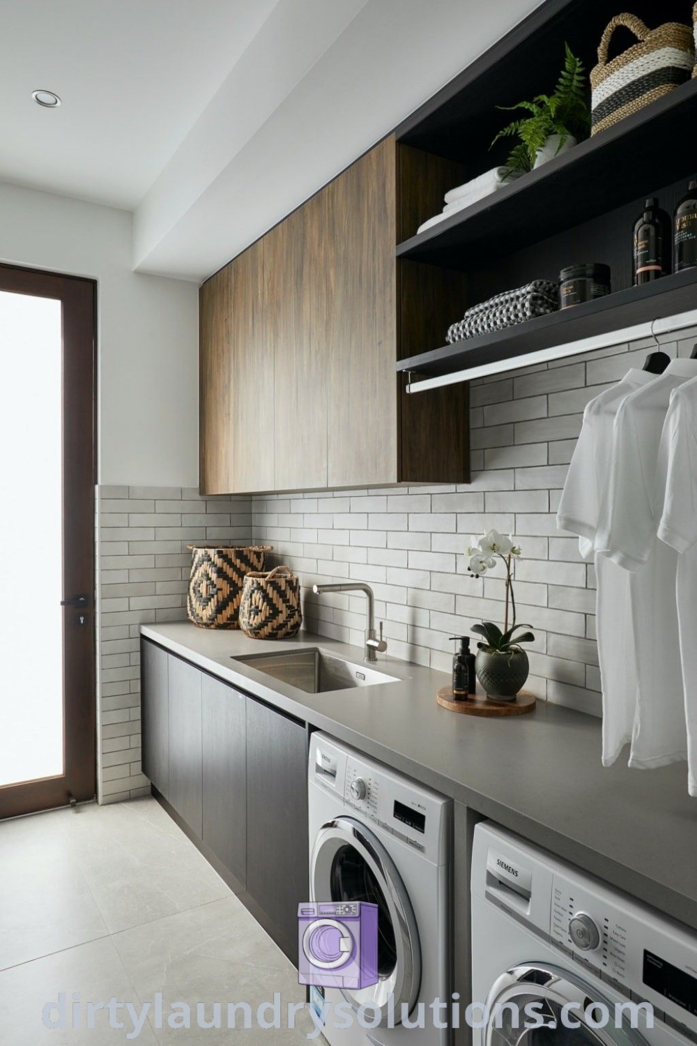 A cozy laundry room showcasing a washer and dryer between open shelves, reflecting modern laundry designs and organization ideas for utility spaces. Discover more inspiring laundry room renovations at dirtylaundrysolutions.com.