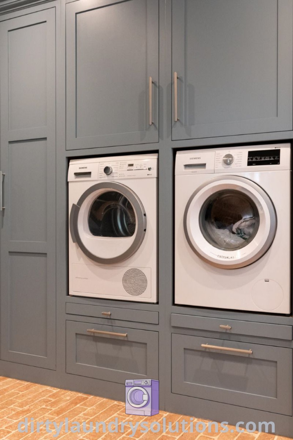 A laundry room featuring a washer and dryer with gray cupboards on the wall, offering cozy ideas and organization solutions. Discover more inspiring utility room designs and ideas for busy homes at dirtylaundrysolutions.com.