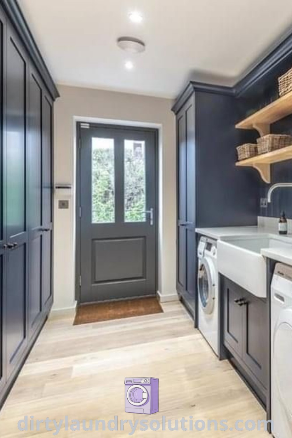 A long narrow laundry room featuring a washer and dryer in the middle, exemplifying mudroom utility room ideas with ample cleaning storage. Discover more inspiring solutions and organization ideas at dirtylaundrysolutions.com.