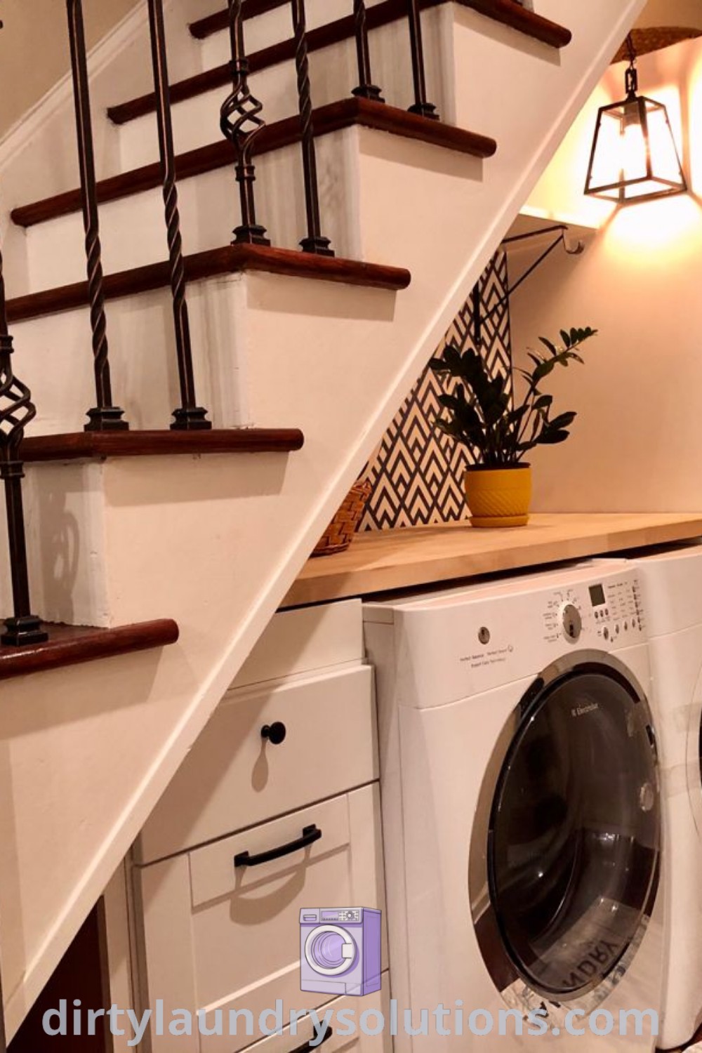 A washer and dryer located under the stairs in a cozy laundry room, showcasing efficient use of space with inspiring organization ideas. Discover solutions to freshen up your space at dirtylaundrysolutions.com.