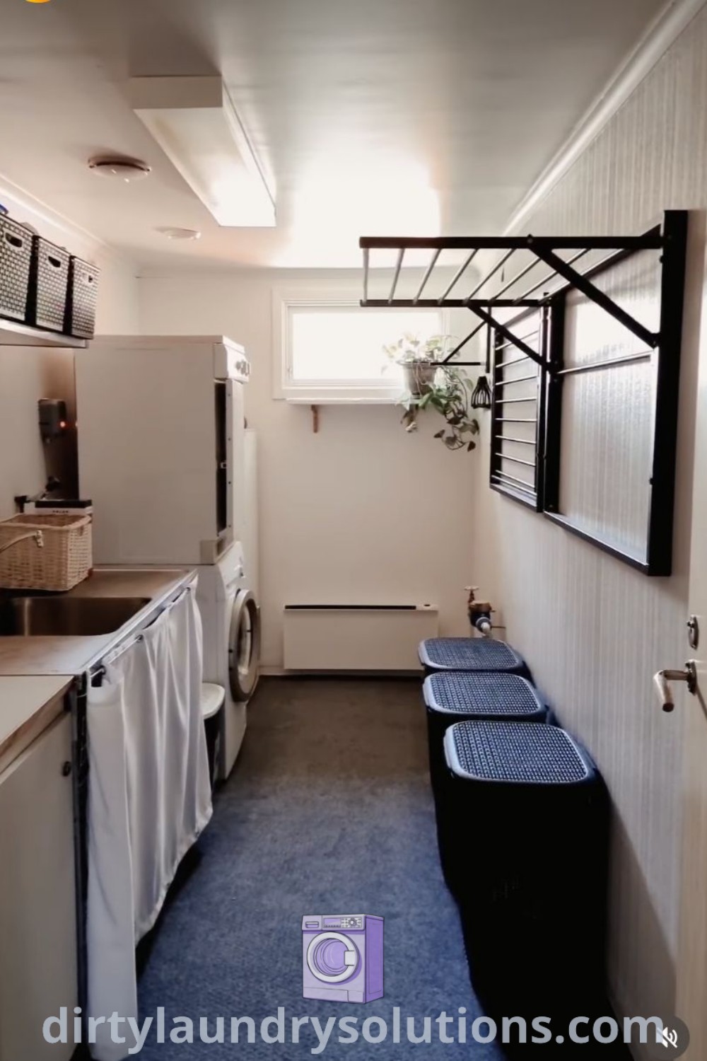 A clean laundry room with a cleaning closet, hanging clothes to dry inside, and organized space ideas for your home. Discover more cozy laundry room inspirations at dirtylaundrysolutions.com.