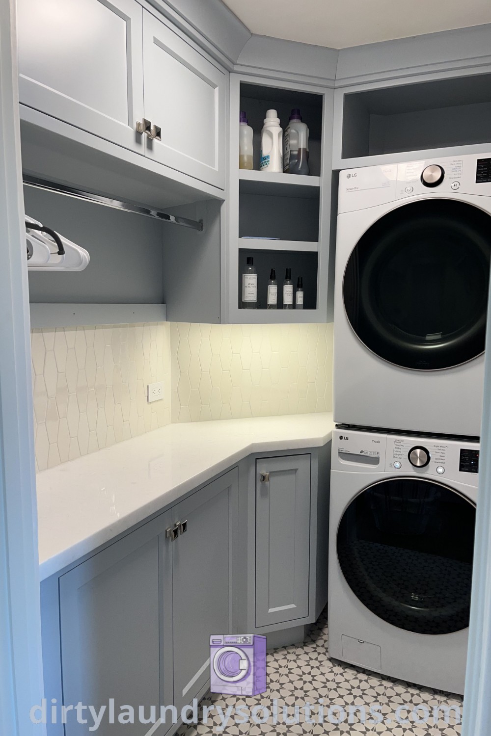 A cozy small laundry room with a stackable washer and dryer, corner cabinet, and organized shelving, showcasing decoration and flooring ideas. Discover styling tips and solutions for your home at dirtylaundrysolutions.com.