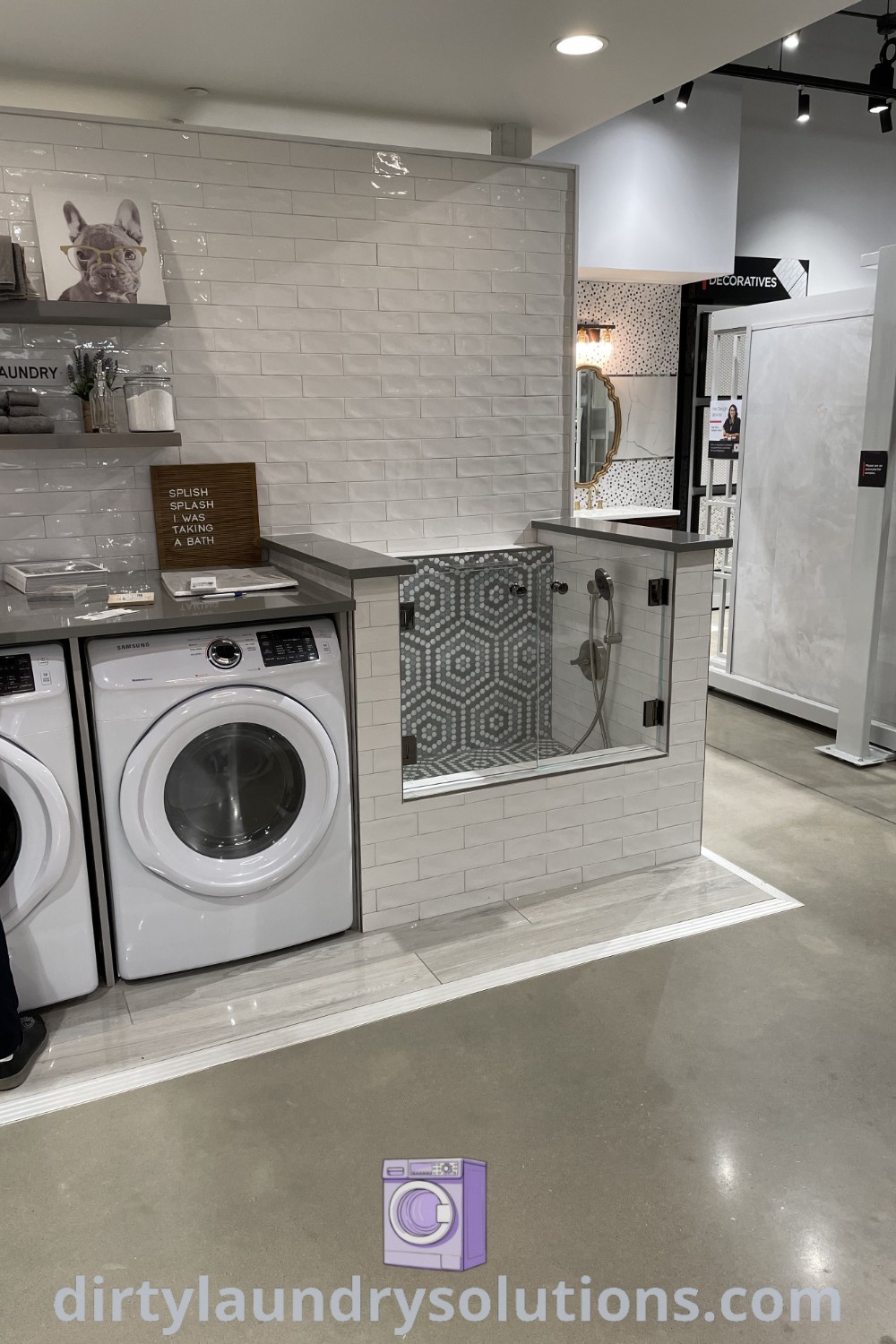 A modern laundry room with a washer and dryer, and a dedicated dog wash area, showcasing a functional design that is both stylish and practical. Find unique ideas for your home at dirtylaundrysolutions.com.