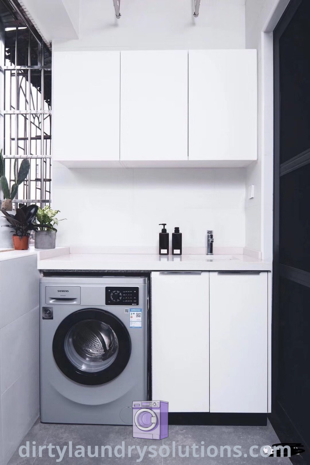 A washer and dryer in a small utility area with white wall cabinets, demonstrating effective space organization and inviting decor ideas. Find unique utility area design inspirations at dirtylaundrysolutions.com.