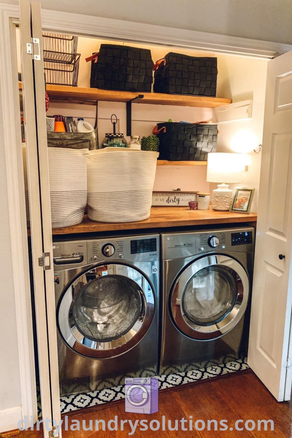 A washer and dryer in a small room with open shelves, showcasing cozy laundry alcove ideas perfect for small spaces. Discover inspiring designs for your home at dirtylaundrysolutions.com.