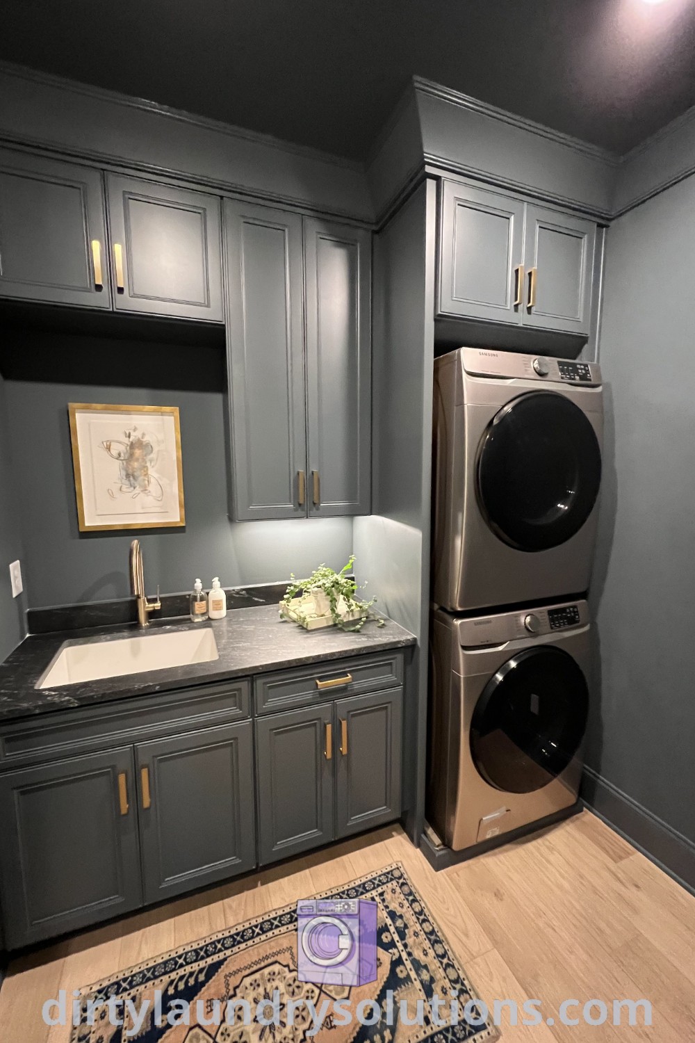A modern stacked laundry setup in a stylish kitchen next to a cozy rug, showcasing effective organization ideas and inspiring design concepts. Explore cozy laundry room inspirations at dirtylaundrysolutions.com.
