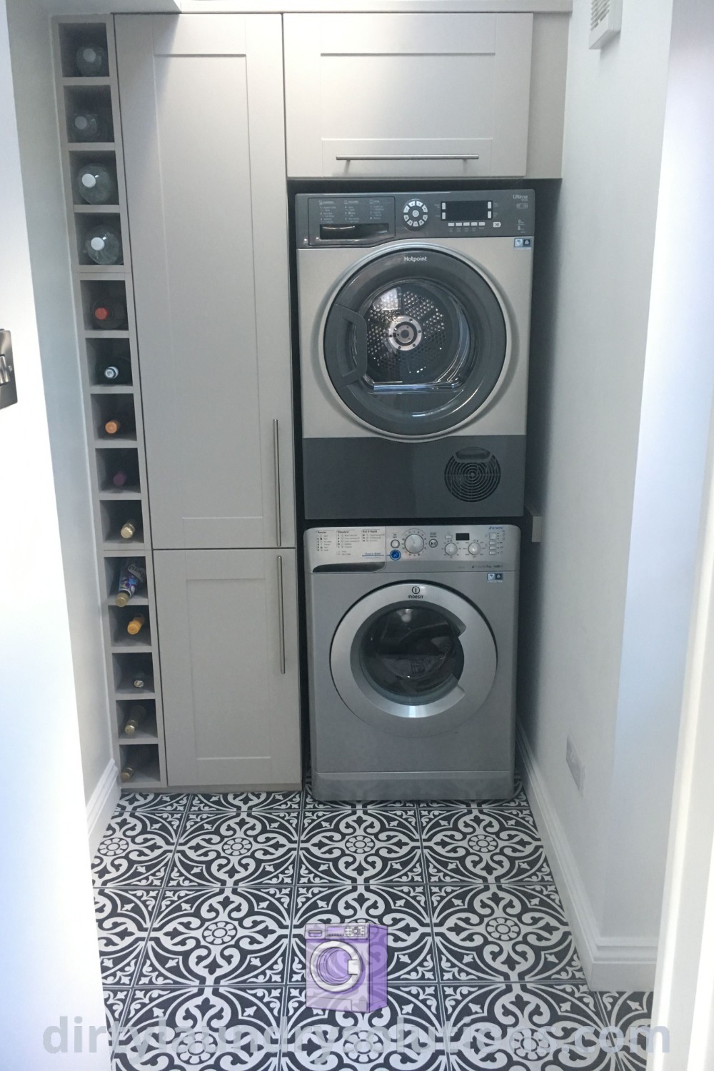 A cozy utility room featuring a washer and dryer in a corner, complemented by tile flooring, exemplifying organized design ideas for small laundry rooms. Discover more inspiring solutions for your home at dirtylaundrysolutions.com.