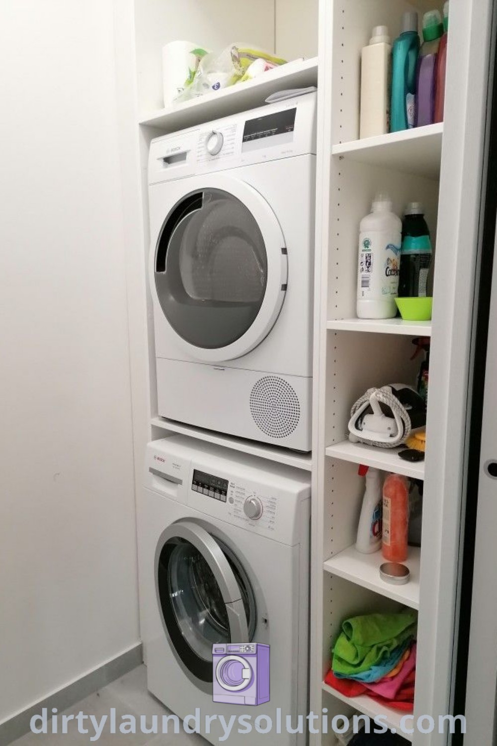 A stackable washer and dryer in a closet of a beautifully organized bathroom, showcasing concealed appliances and cabinet solutions, perfect for maximizing space in small homes. Explore more unique ideas and organization tips at dirtylaundrysolutions.com.