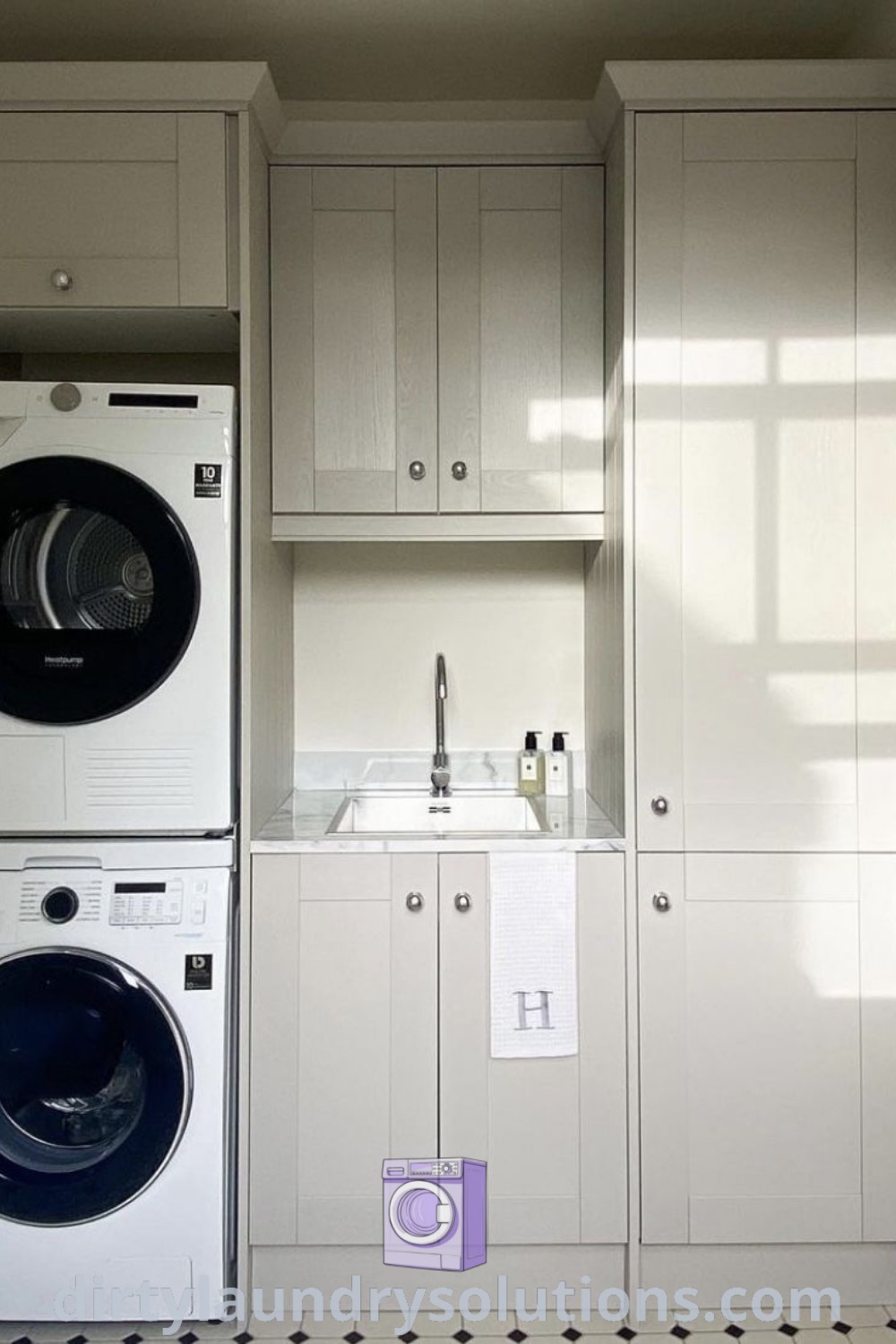 A cozy utility room featuring a washer and dryer next to each other with cabinets, perfect for small white laundry room ideas. Explore unique solutions and inspiring designs for your home at dirtylaundrysolutions.com.