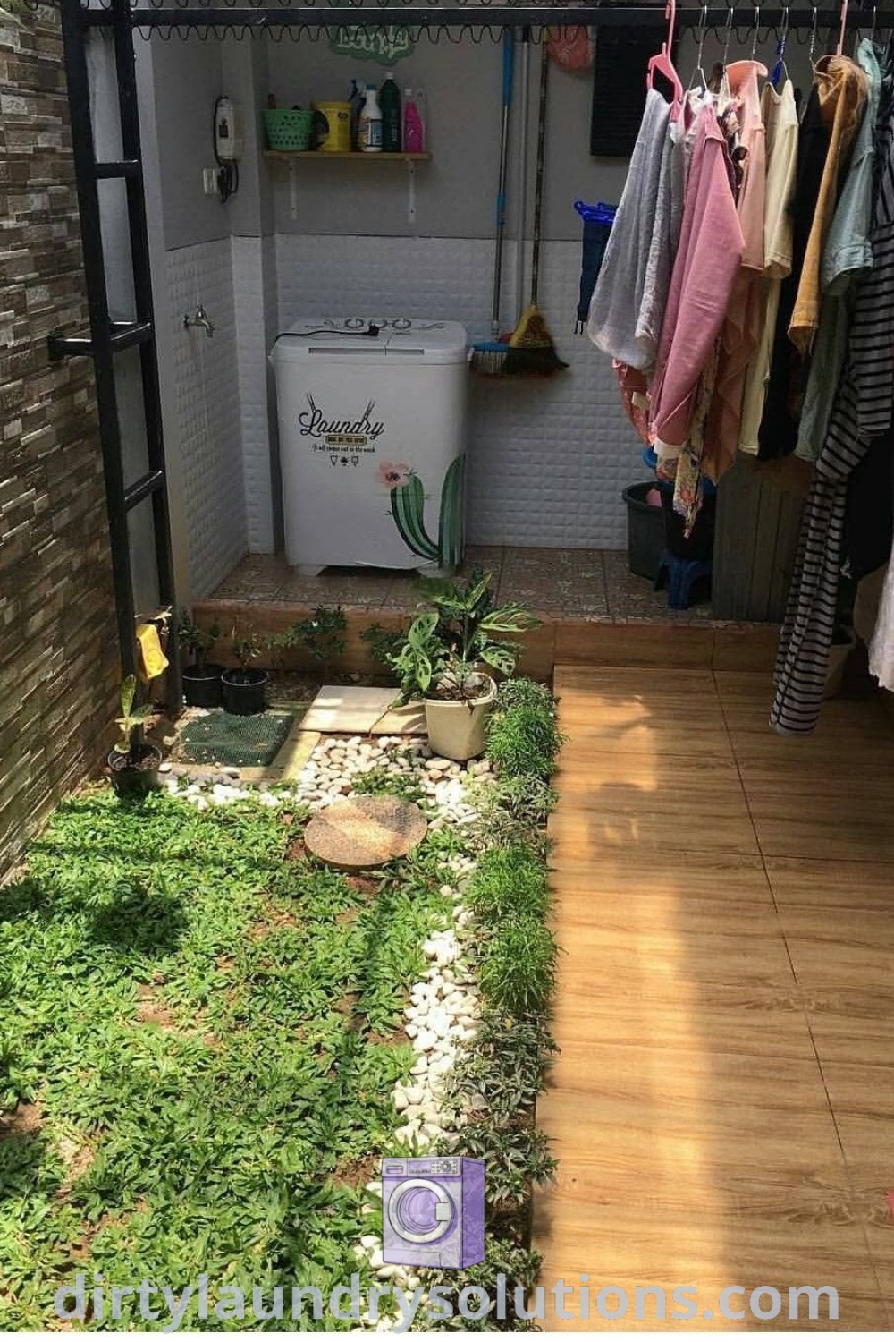 An outdoor closet with clothes hanging on a rack surrounded by green grass in the yard, perfect for a backyard laundry area. Discover the best outdoor laundry rooms and design ideas at dirtylaundrysolutions.com.