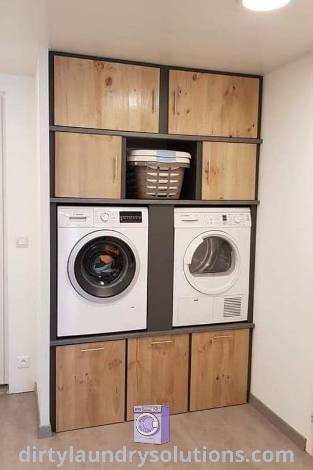 A modern laundry room featuring a washer and dryer under wooden cabinets, showcasing cozy design ideas and storage solutions. Explore more inspiring laundry room renovations at dirtylaundrysolutions.com.