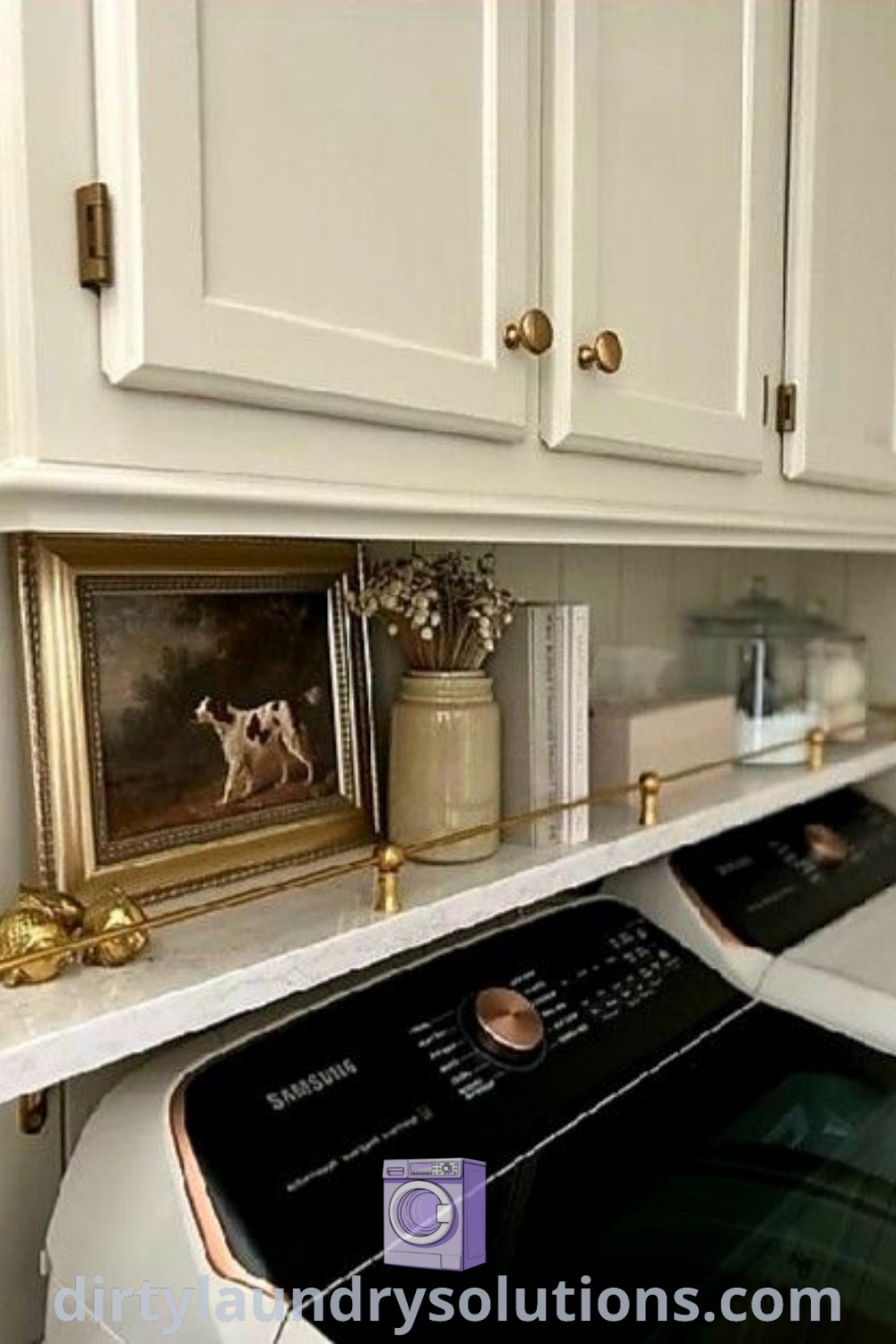 A white washer and dryer sitting in a stylish kitchen next to cabinets with gold knobs, showcasing functional design ideas for laundry rooms. Discover cozy and inspiring laundry room solutions at dirtylaundrysolutions.com.