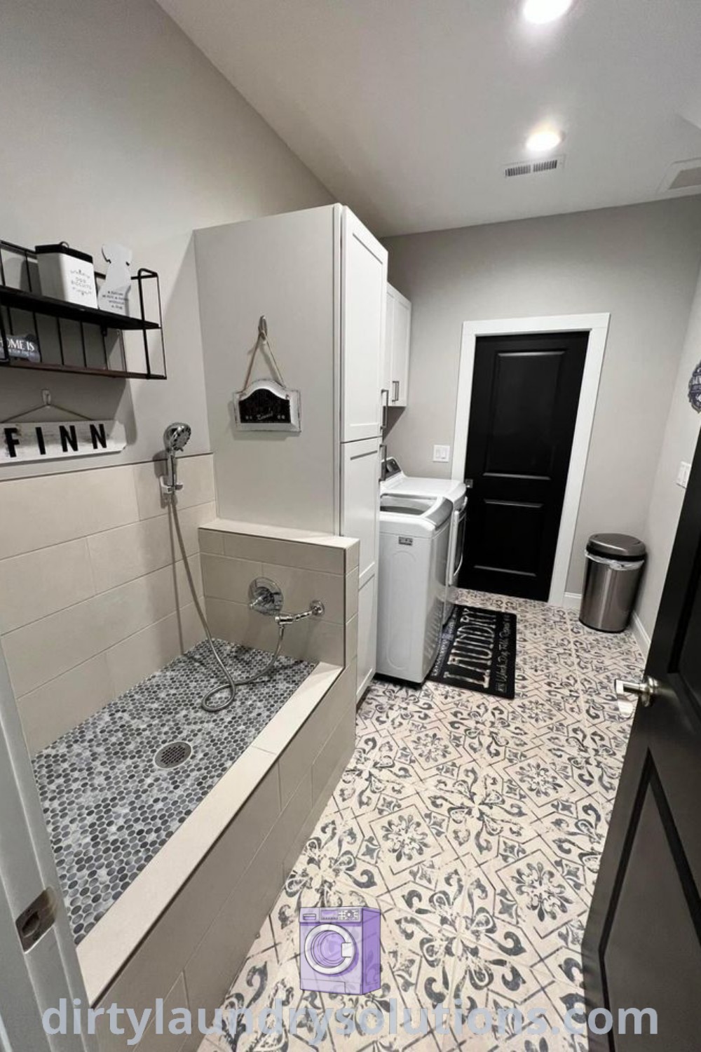 A cozy bathroom with a sink, washer, and dryer, showcasing a stylish dog bath station and shower for pets, ideal for busy homes. Discover unique dog shower ideas at dirtylaundrysolutions.com.