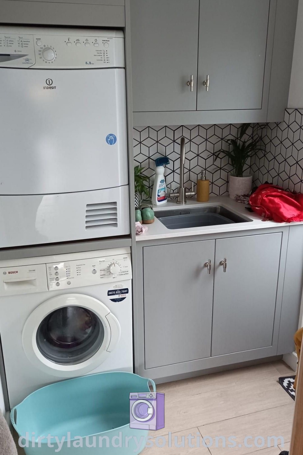 A stacked washing machine and tumble dryer in a small kitchen setting, demonstrating efficient use of space with organized solutions for busy homes. Discover inspiring ideas for laundry room decor at dirtylaundrysolutions.com.