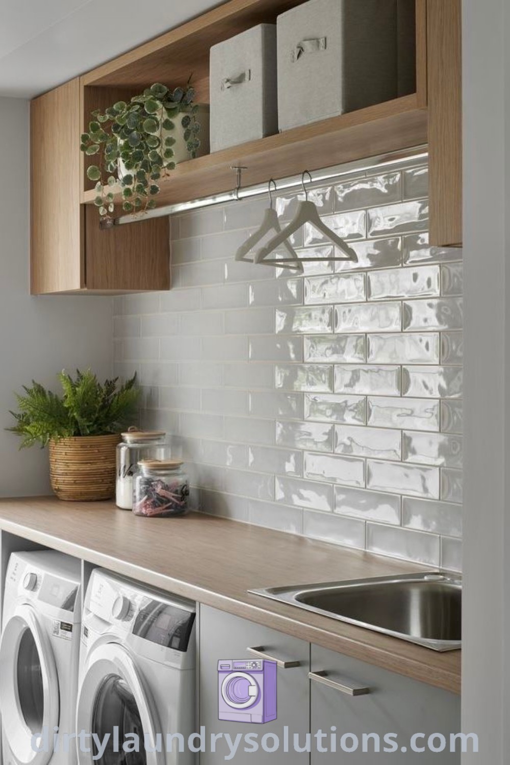 A modern washer and dryer in a stylish kitchen laundry room with a beautiful accent wall next to a window. This space offers inspiring ideas for apartment laundry room organization and cozy aesthetics. Discover more about laundry room designs and organization ideas at dirtylaundrysolutions.com.