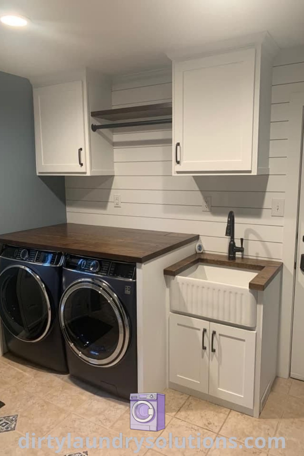 A cozy garage laundry area with a washer and dryer in a small room featuring white cupboards on the walls, showcasing unique solutions to maximize space. Discover more inspiring ideas for your home at dirtylaundrysolutions.com.