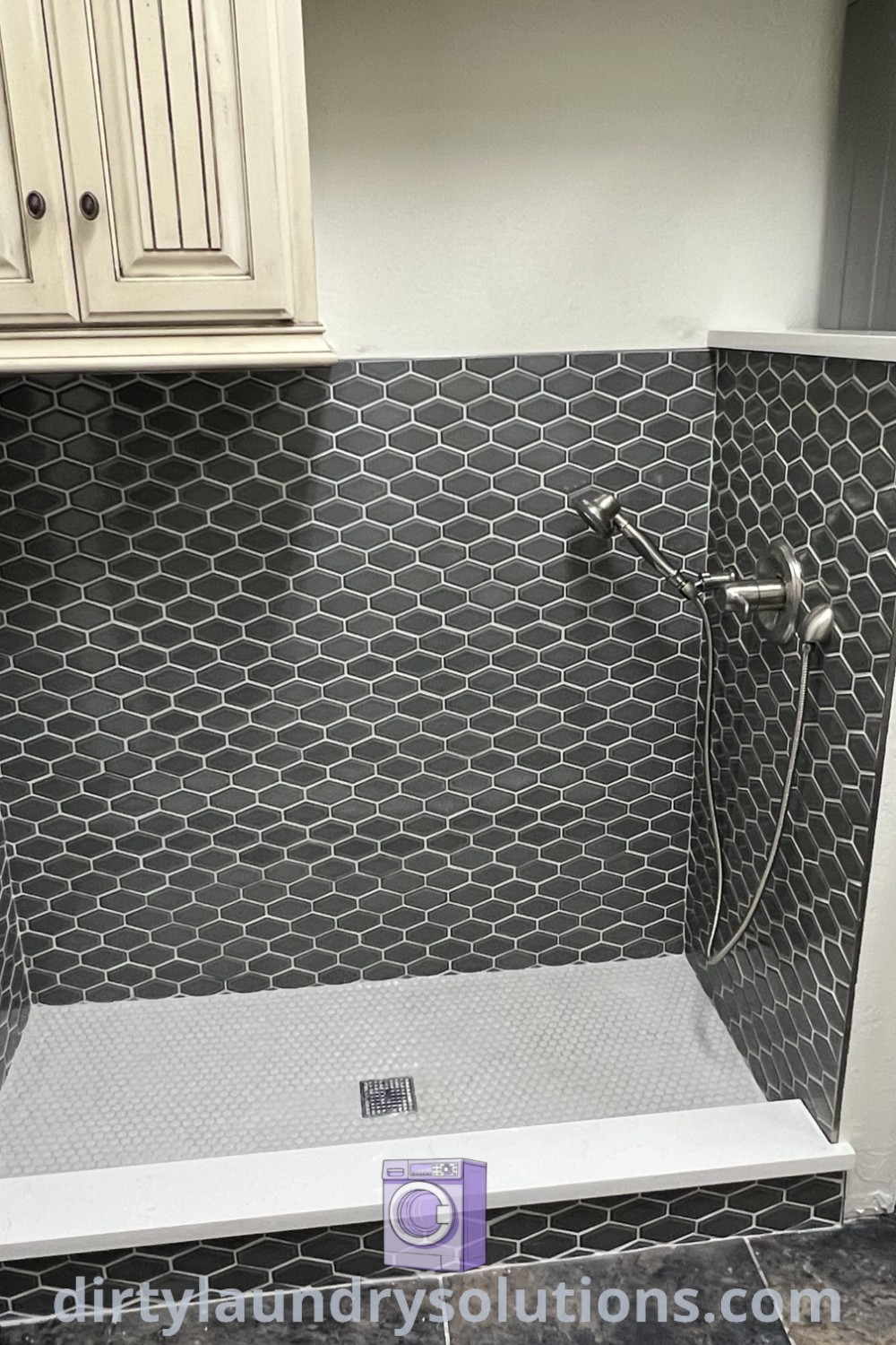 A washer and dryer beside a mop sink in a stylish laundry room with white cabinets, enhancing functionality as a wash station and dog bathroom. Discover inspiring ideas for your home at dirtylaundrysolutions.com.