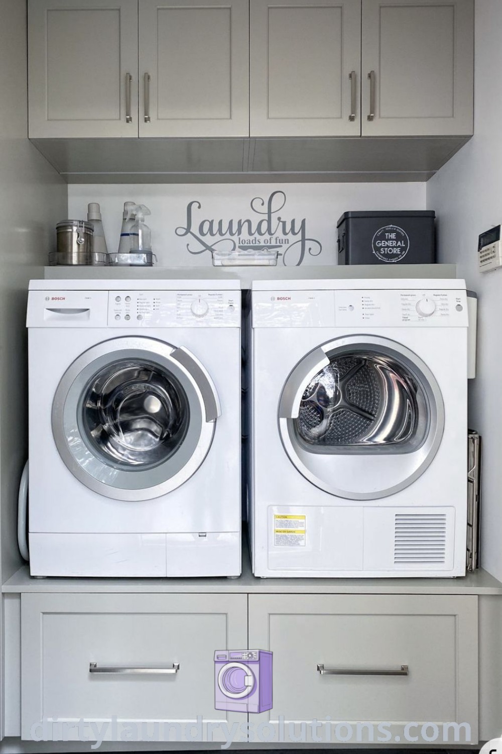 A modern laundry room showcasing a washer and dryer next to cabinets labeled "laundry," featuring modular cabinets and cozy organization ideas, perfect for busy homes. Discover inspiring laundry room layouts and solutions at dirtylaundrysolutions.com.