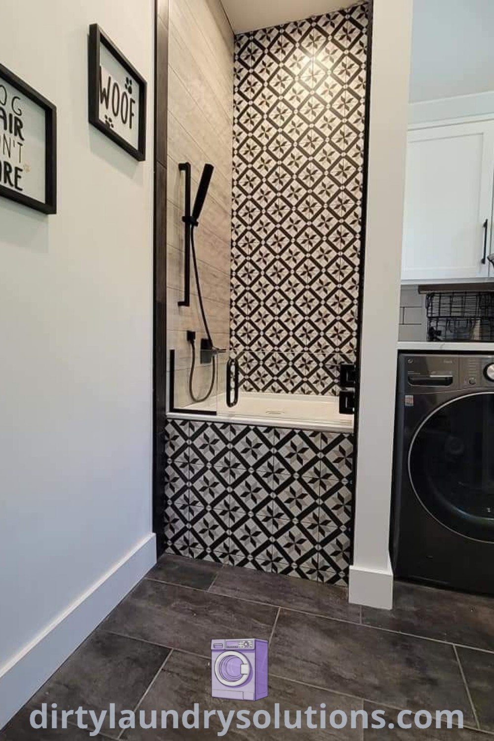 A washer and dryer in a stylish bathroom with black and white wallpaper, showcasing a cozy design for small spaces. Ideal for a laundry room combo or pet washing station. Discover more home decor inspirations and solutions at dirtylaundrysolutions.com.