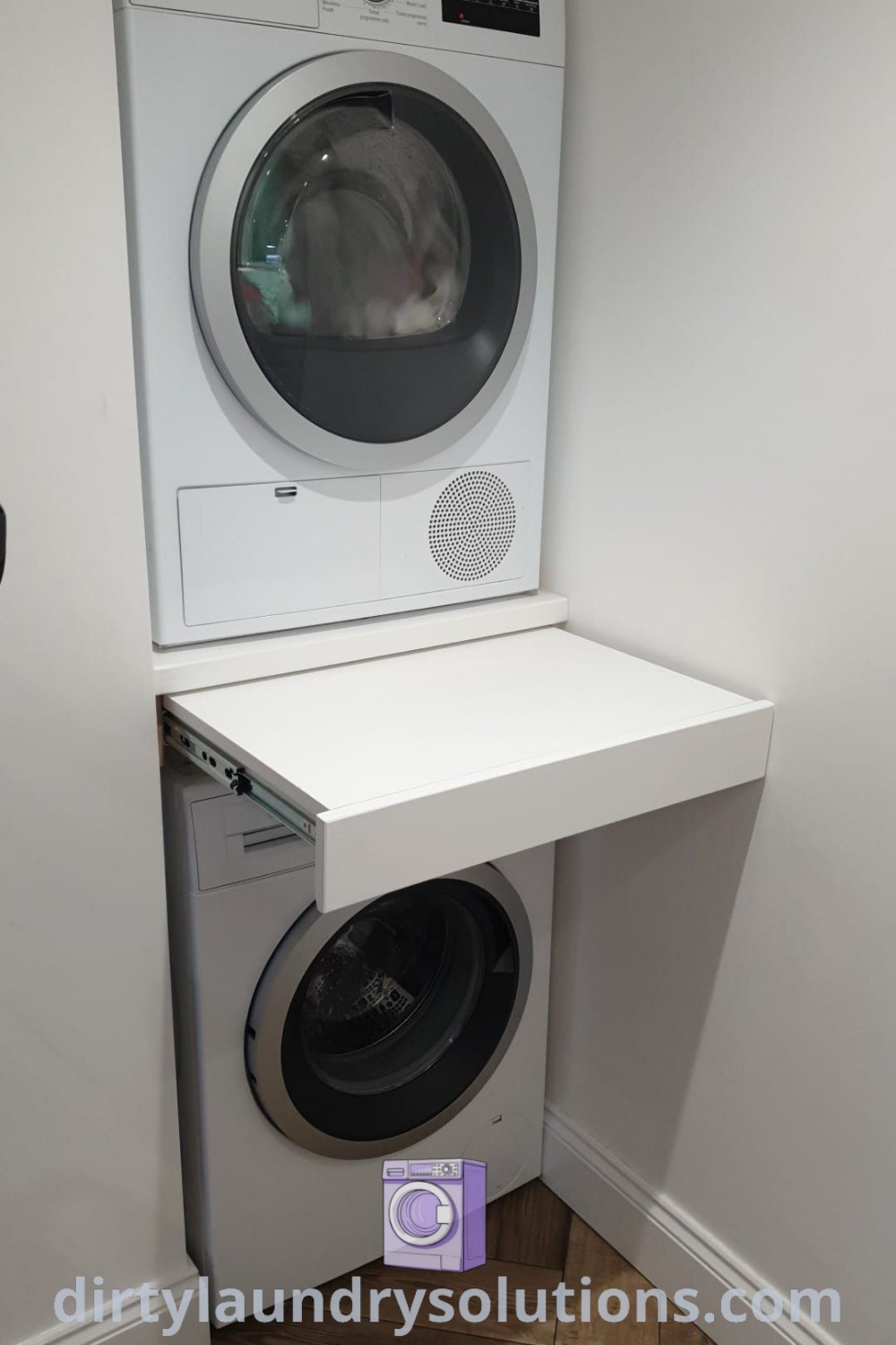 A cozy stacked washer and dryer in a modern garage design, demonstrating stylish laundry room and utility room ideas. Explore inspiring solutions at dirtylaundrysolutions.com.