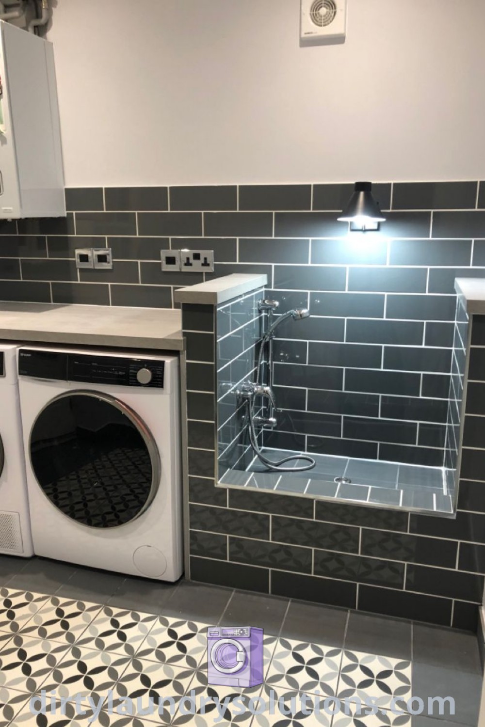 A small laundry room with a washer and dryer, featuring tile flooring and a washing station, showcasing cozy ideas and design inspirations for effective laundry room renovations. Discover unique solutions at dirtylaundrysolutions.com.