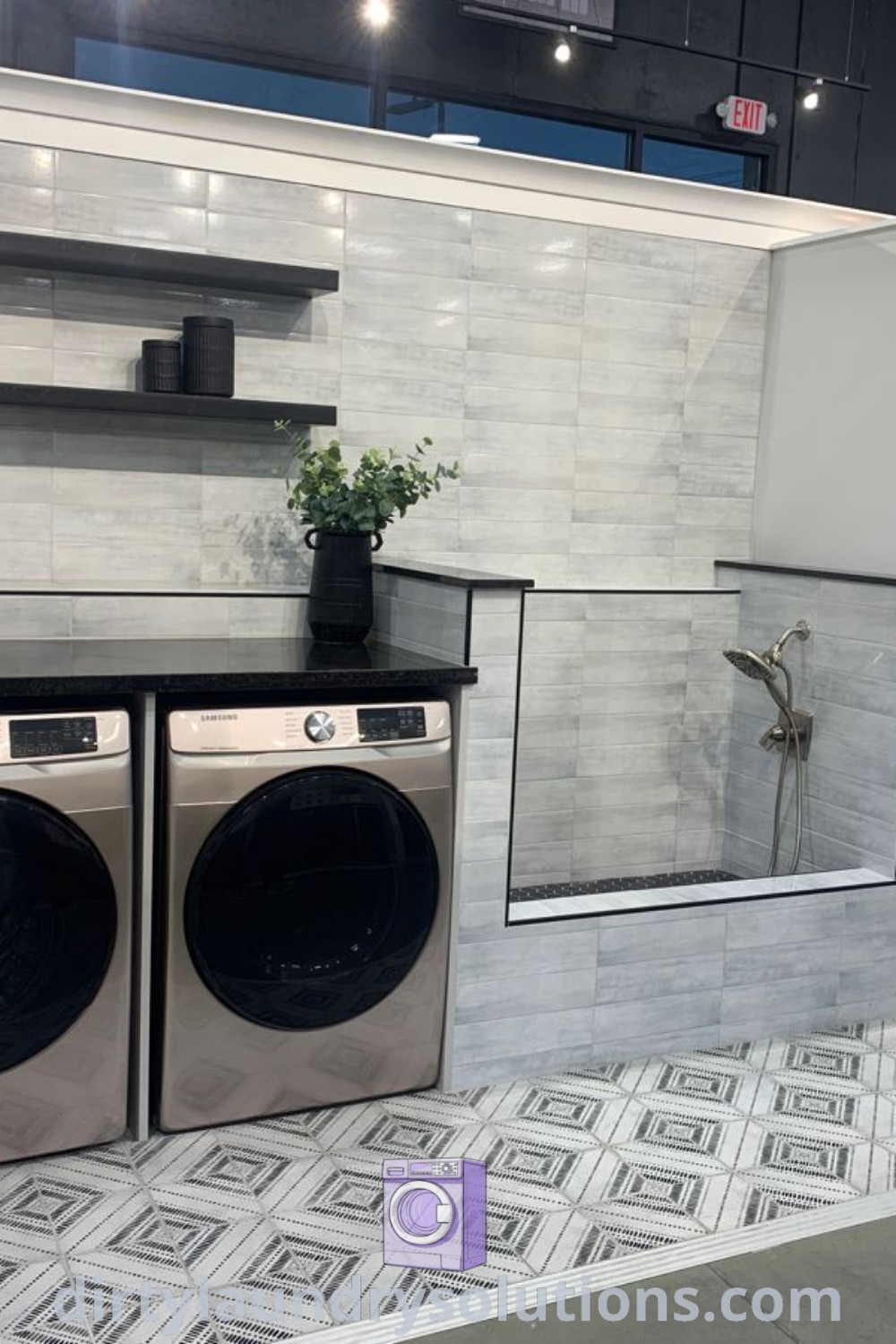 A washer and dryer on display in a stylish showroom with tile flooring, featuring a cozy dog shower for laundry room dog wash ideas. Explore inspiring solutions and organization ideas for busy homes at dirtylaundrysolutions.com.